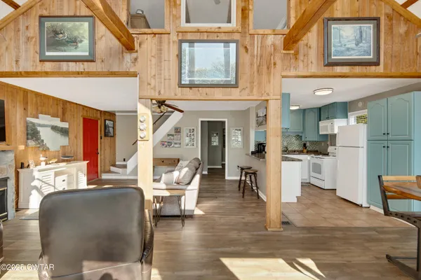 a living room with furniture a fireplace and kitchen view
