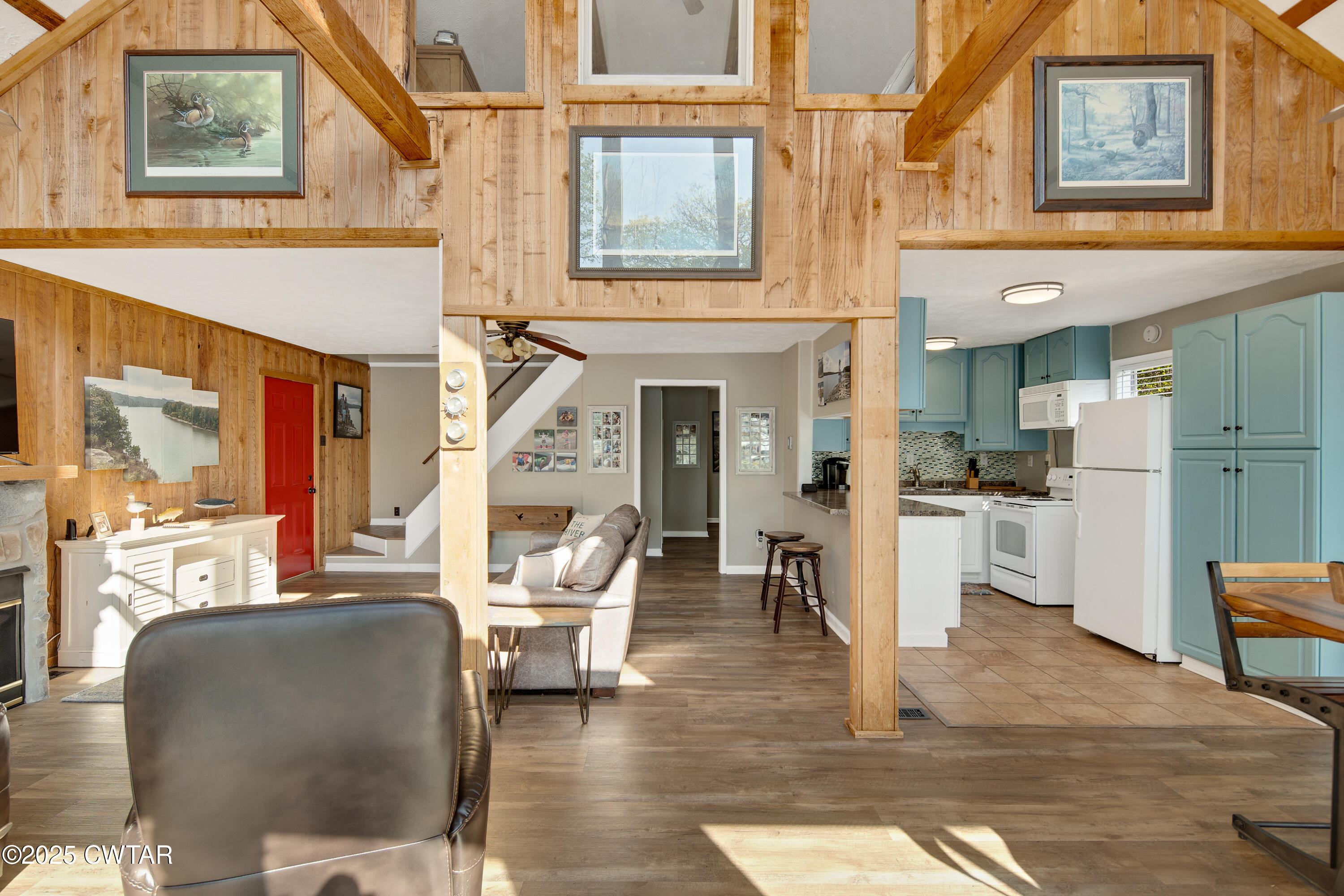 229 Bill Perry Drive Sugar Tree, TN 38380 - Photo 28 of 42 a living room with furniture a fireplace and kitchen view