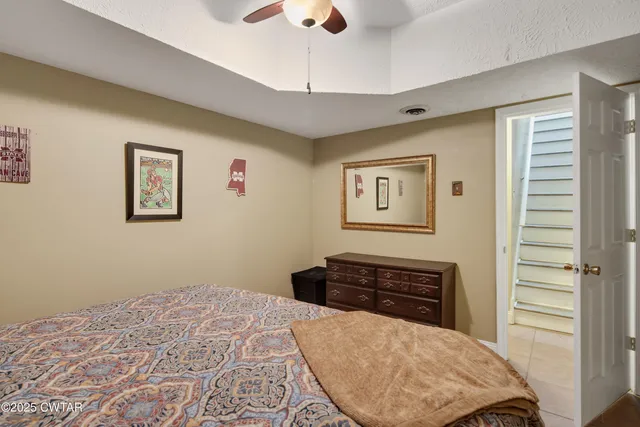 a bedroom with a bed and a dresser