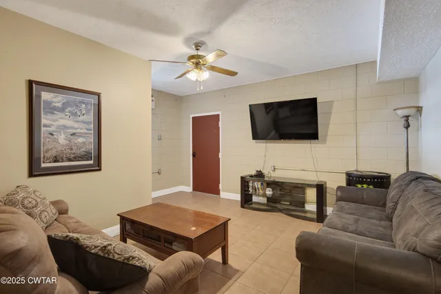 a living room with furniture and a flat screen tv