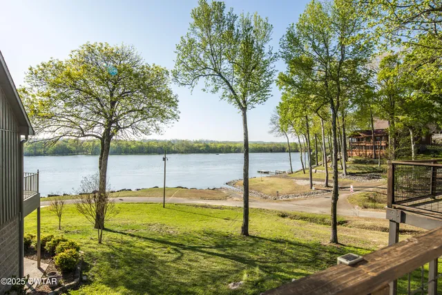 a view of a balcony with wooden floor next to a iron stairs