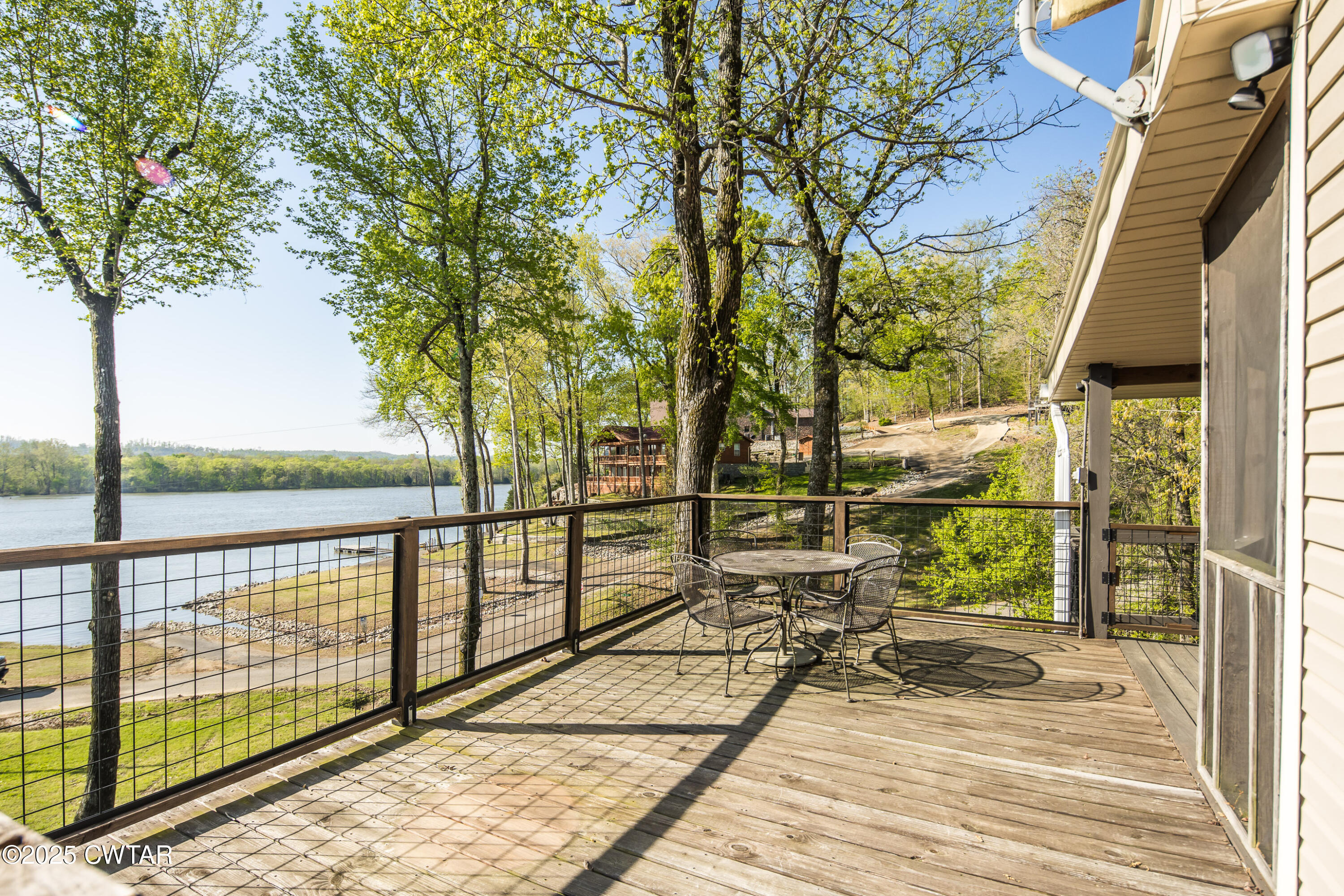 229 Bill Perry Drive Sugar Tree, TN 38380 - Photo 35 of 42 a view of a balcony with wooden floor next to a iron stairs