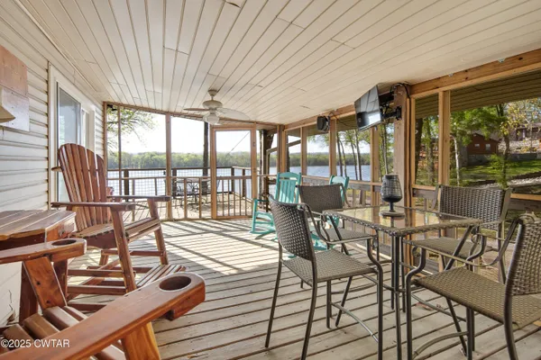 a view of a patio with table and chairs with wooden floor