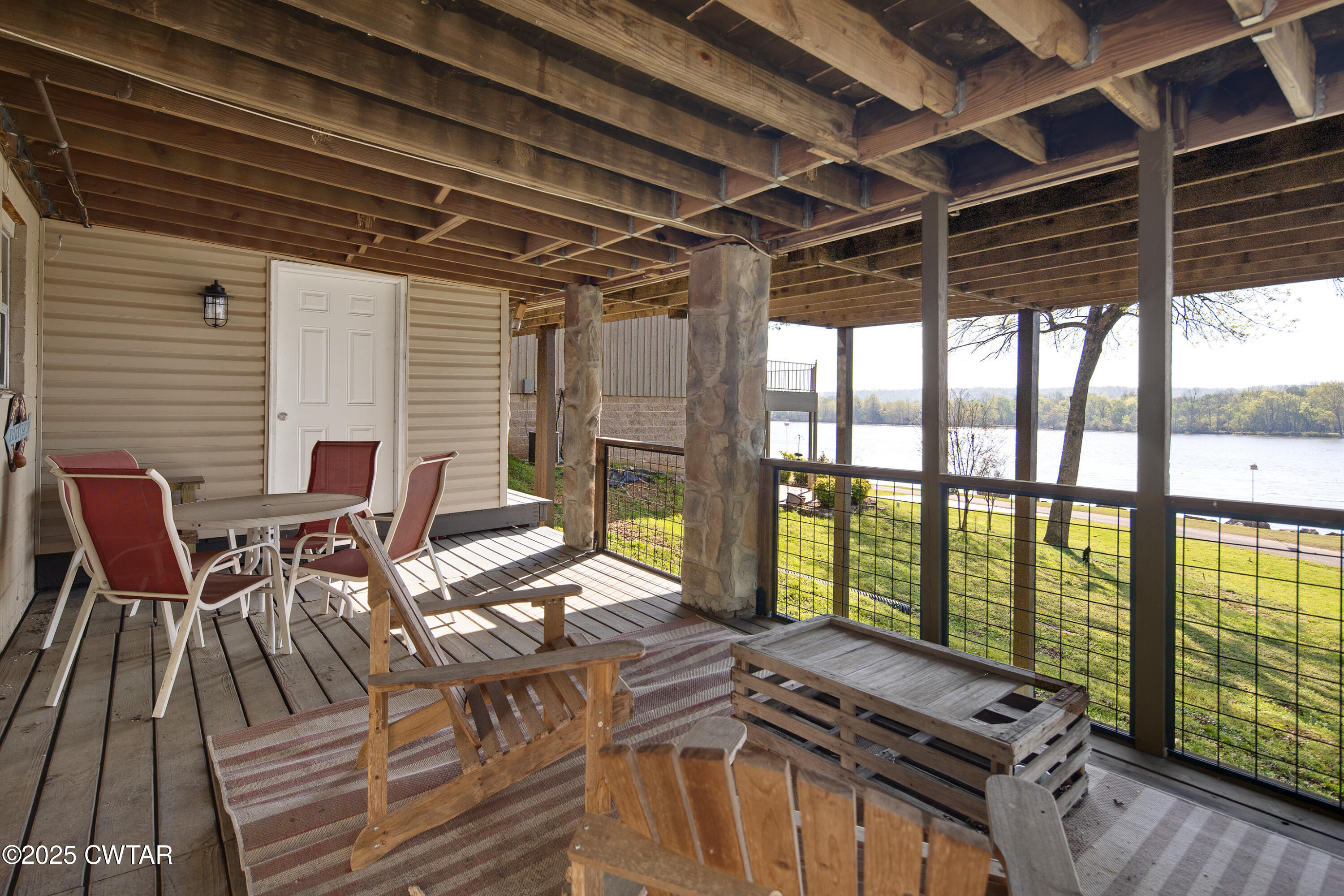 229 Bill Perry Drive Sugar Tree, TN 38380 - Photo 37 of 42 a view of a patio with table and chairs with wooden floor