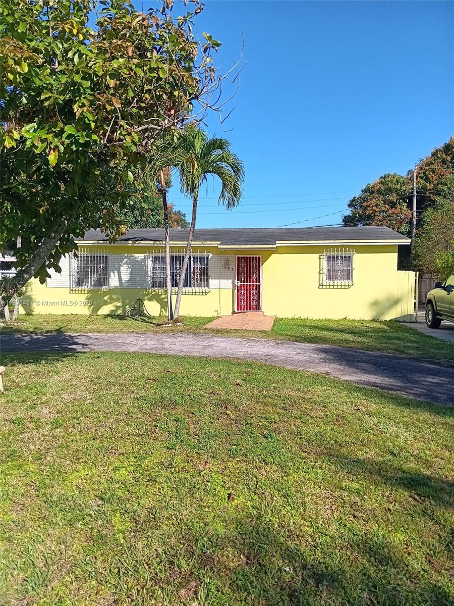 1825 Northwest 112th Street Miami, FL 33167 - Photo 1 of 24 a view of a house with a swimming pool