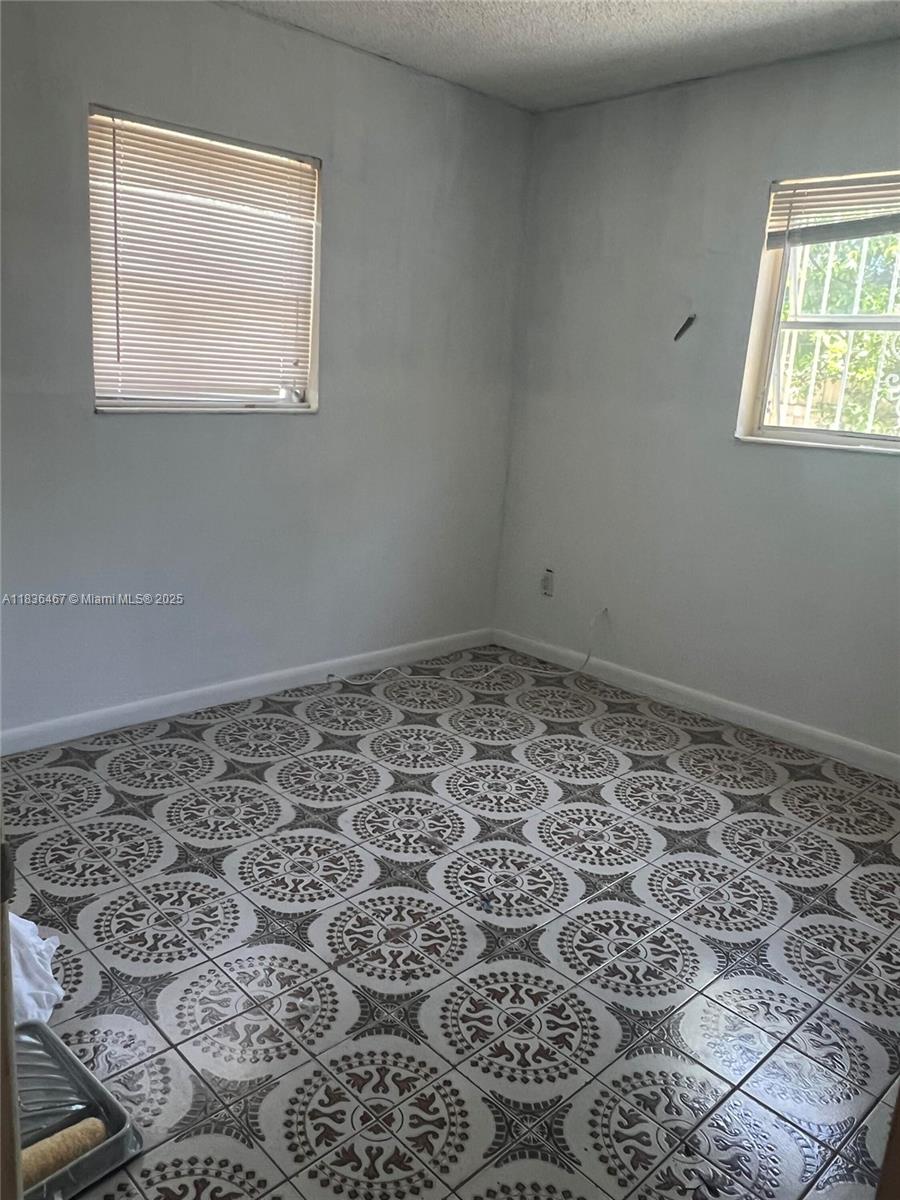 1825 Northwest 112th Street Miami, FL 33167 - Photo 13 of 24 a bathroom with a window