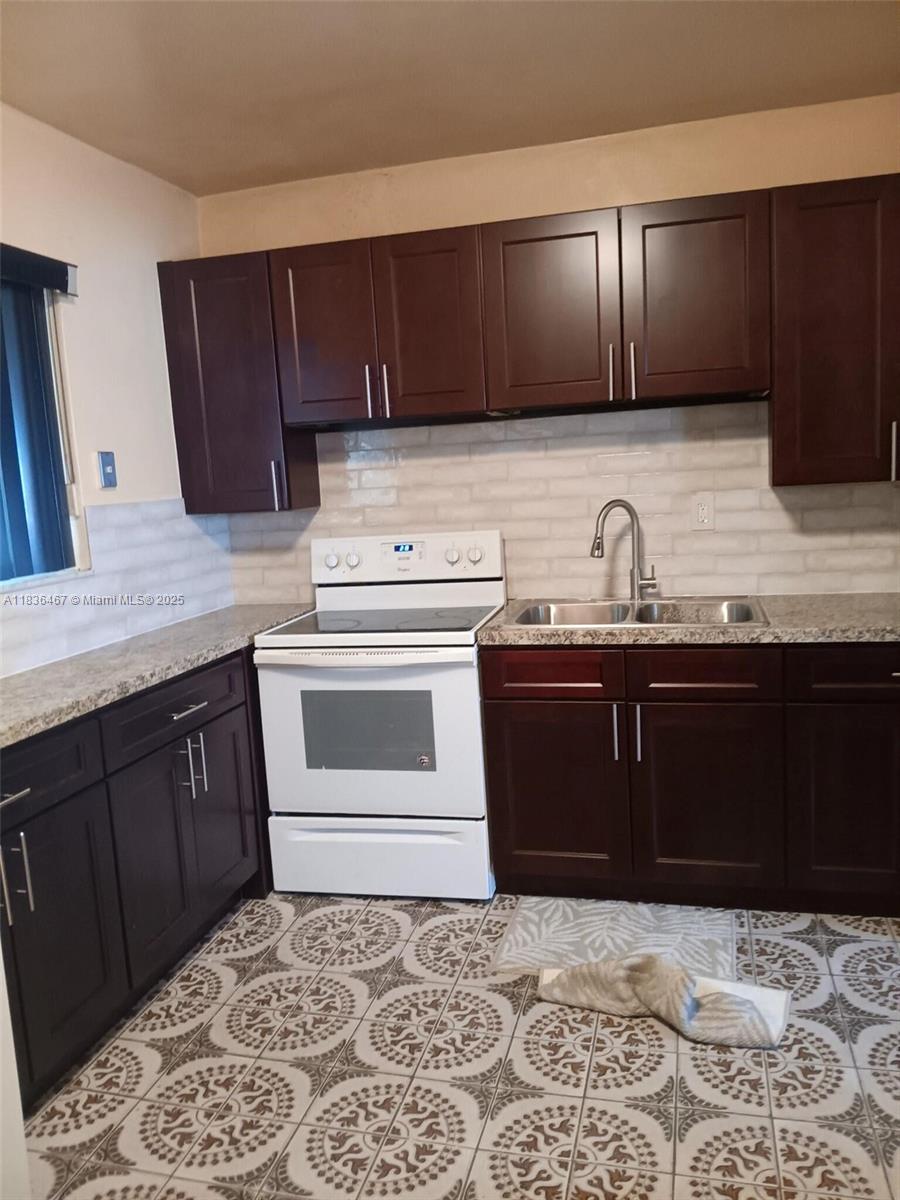 1825 Northwest 112th Street Miami, FL 33167 - Photo 15 of 24 a kitchen with a sink and cabinets