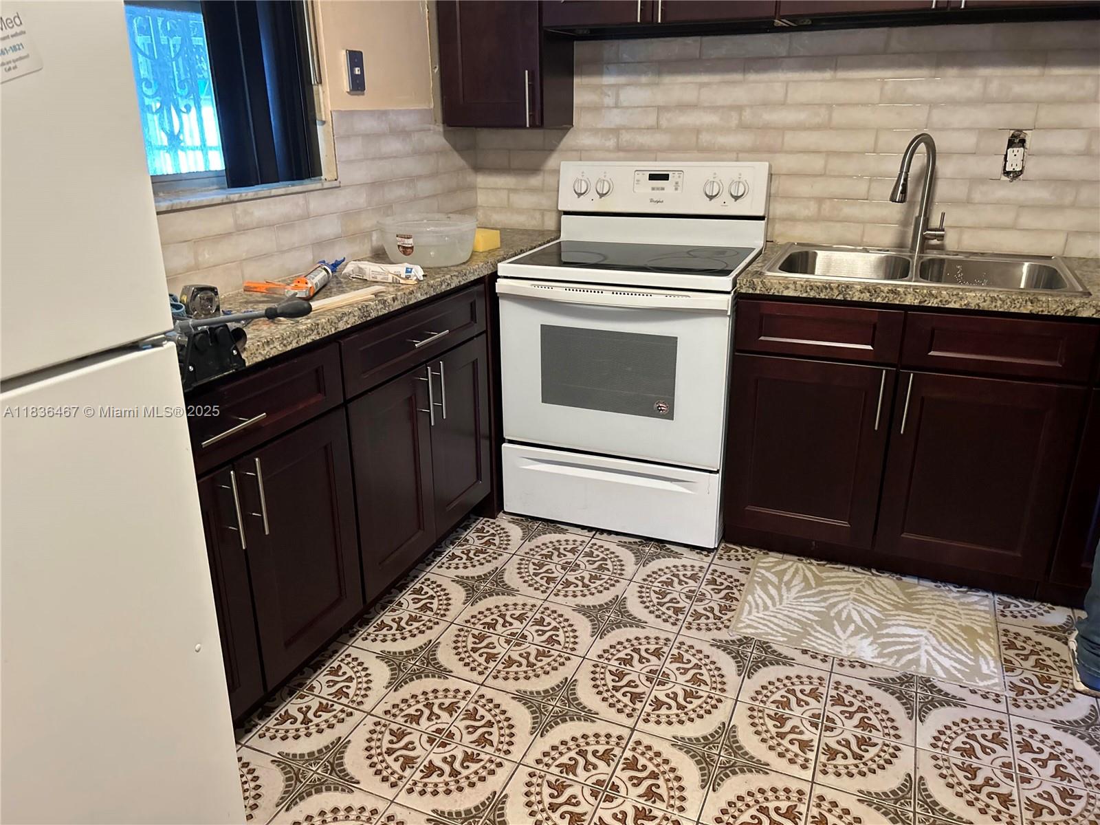1825 Northwest 112th Street Miami, FL 33167 - Photo 17 of 24 a kitchen with a stove and a sink