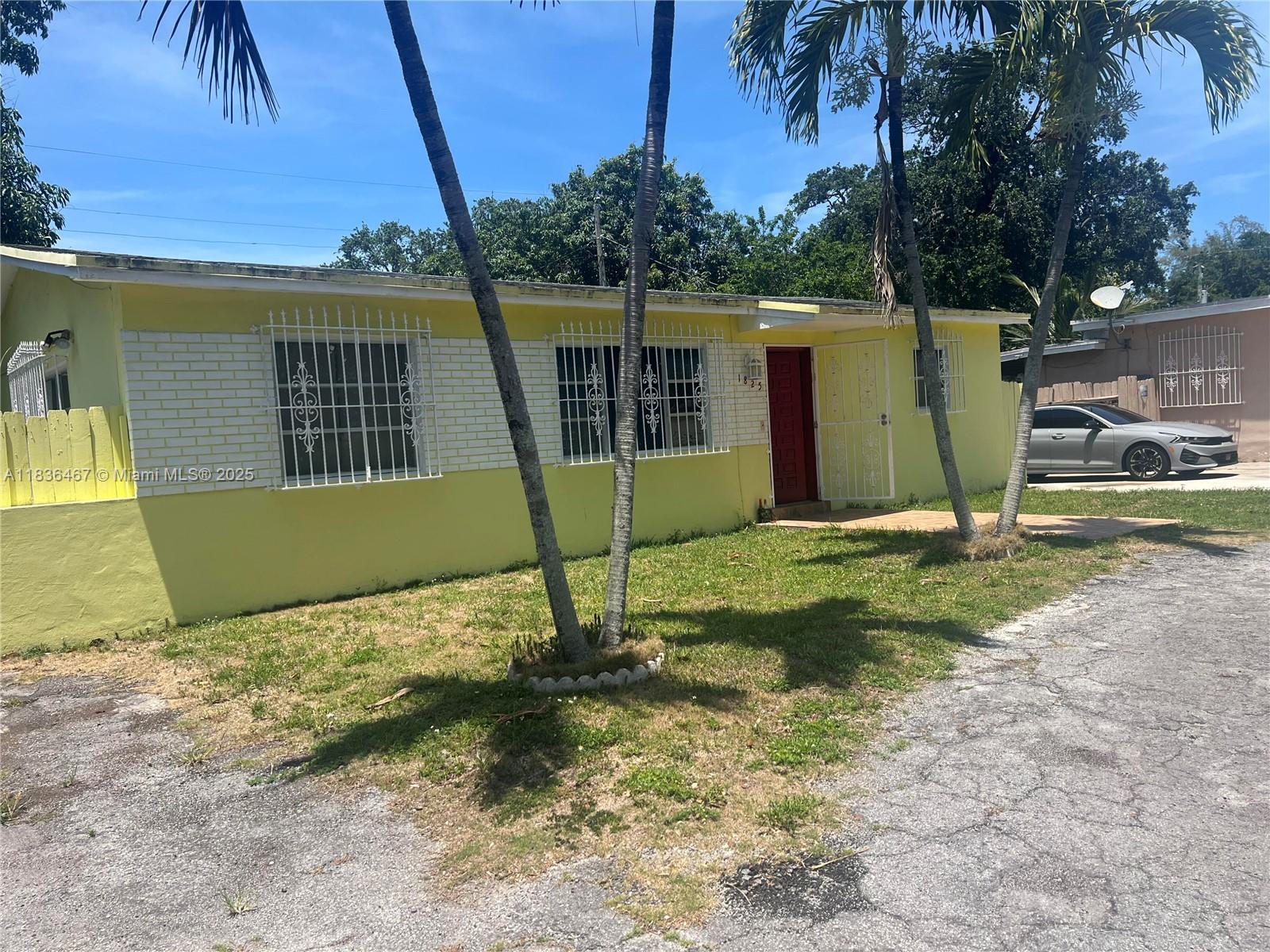 1825 Northwest 112th Street Miami, FL 33167 - Photo 2 of 24 front view of a house with a yard