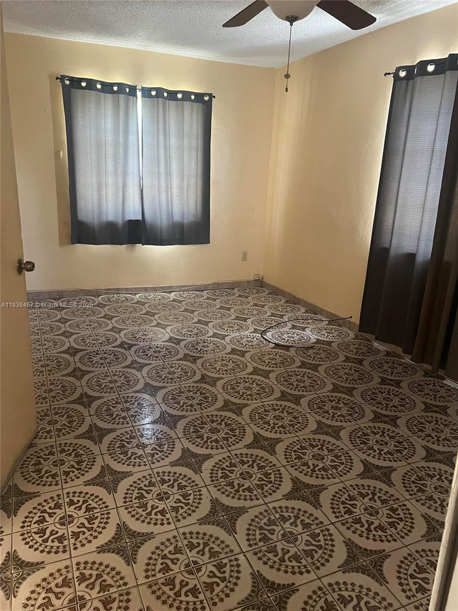 1825 Northwest 112th Street Miami, FL 33167 - Photo 24 of 24 a bathroom with a shower and a toilet