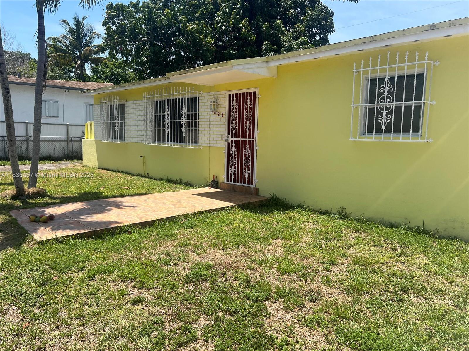 1825 Northwest 112th Street Miami, FL 33167 - Photo 6 of 24 a view of an house with backyard and a tree