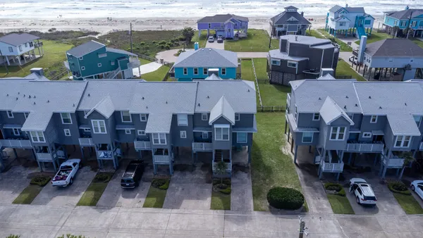 an aerial view of multiple houses with outdoor space