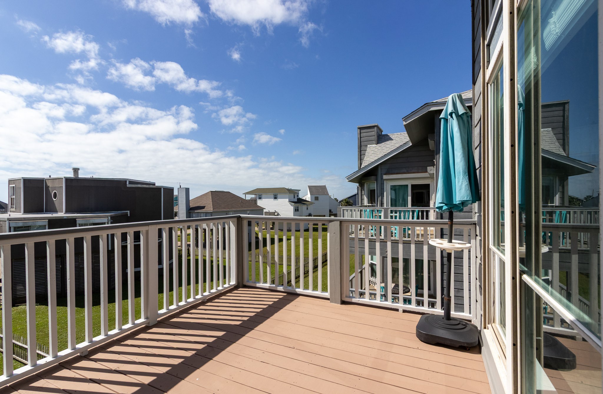 17609 Termini-San Luis Pass Road Galveston, TX 77554 - Photo 18 of 37 a view of balcony with wooden floor and fence