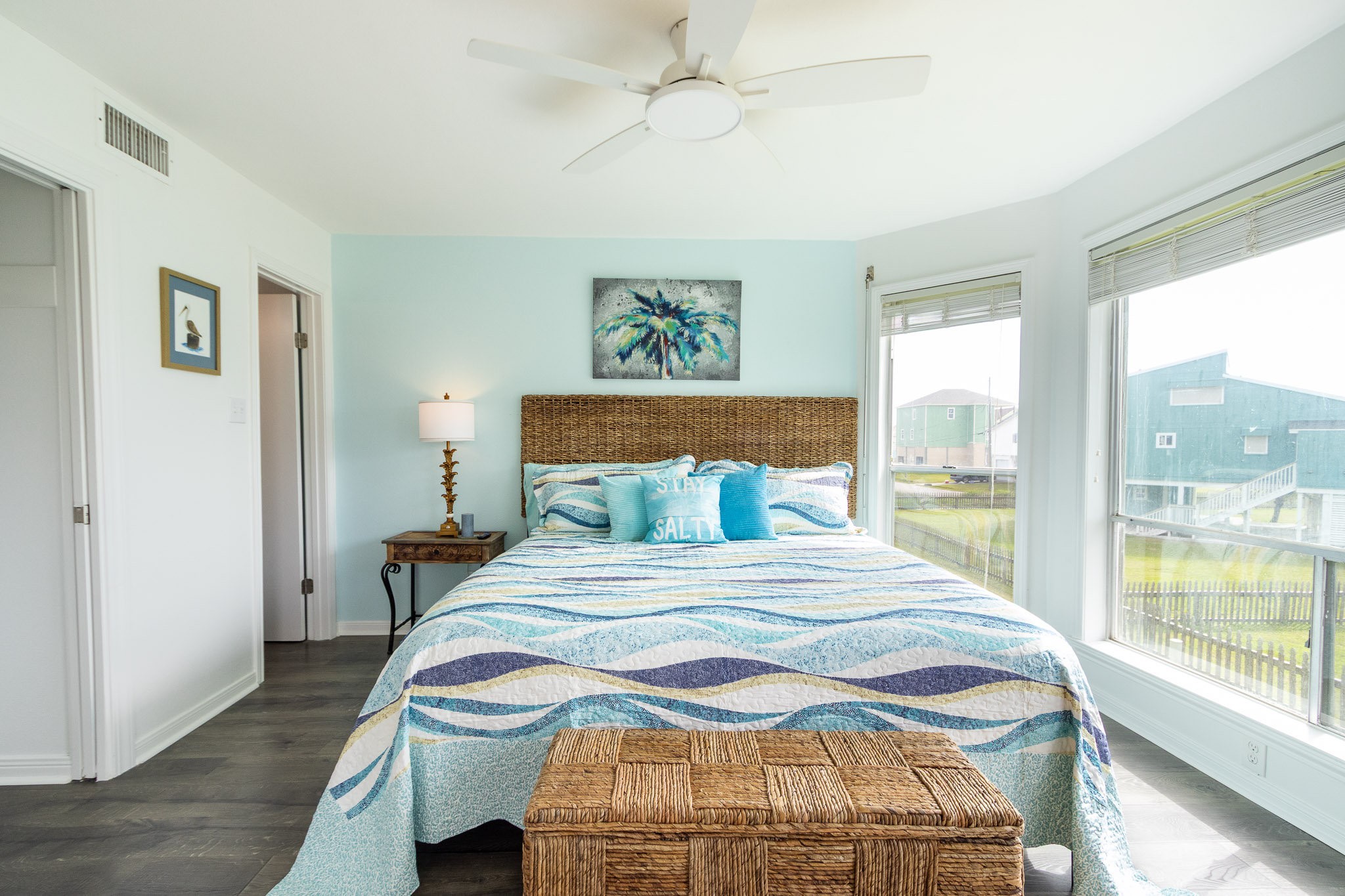 17609 Termini-San Luis Pass Road Galveston, TX 77554 - Photo 8 of 37 a bedroom with a large bed and a chandelier