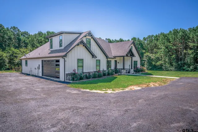a living room with furniture a fireplace and a large window