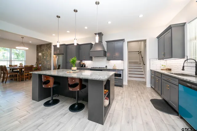 a bathroom with a sink a mirror and a potted plant