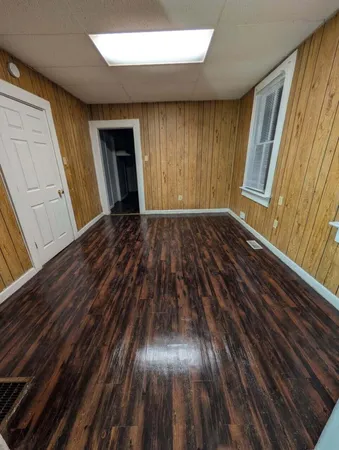 a view of an empty room and wooden floor
