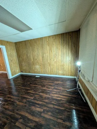 a view of room with window and wooden floor