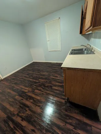 a room with a sink and cabinets