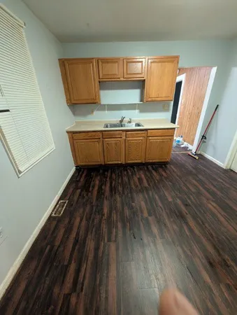 a room with wooden floors and a window