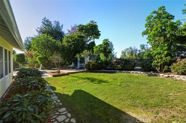 a view of a backyard with large trees