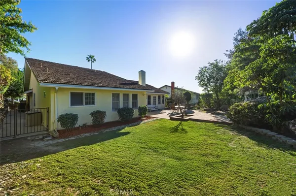 a view of a house with swimming pool and sitting area