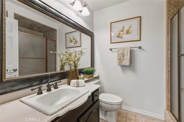 a bathroom with a sink toilet and mirror