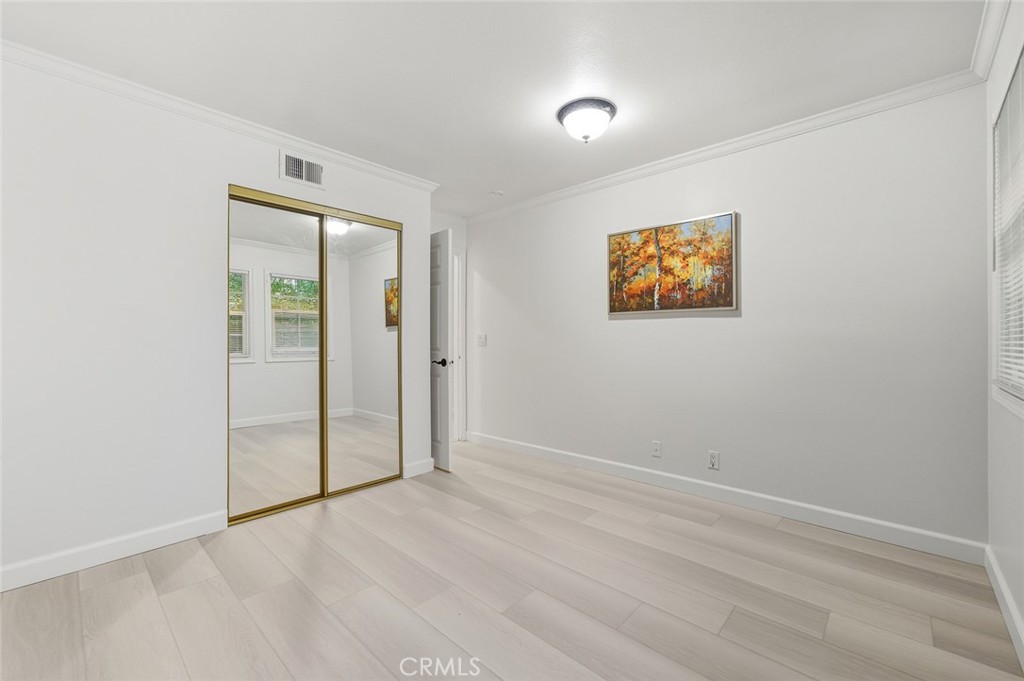 21465 Running Branch Road Diamond Bar, CA 91765 - Photo 22 of 47 an empty room with wooden floor and windows