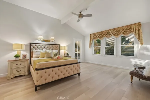 a bedroom with a large bed and a window