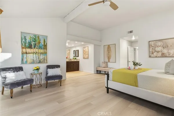 a spacious bedroom with a bed and a table