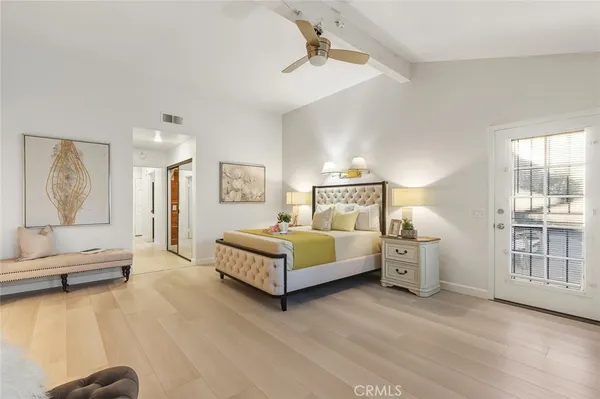 a spacious bedroom with a bed and a large window