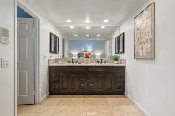 a bathroom with a sink double vanity and a mirror