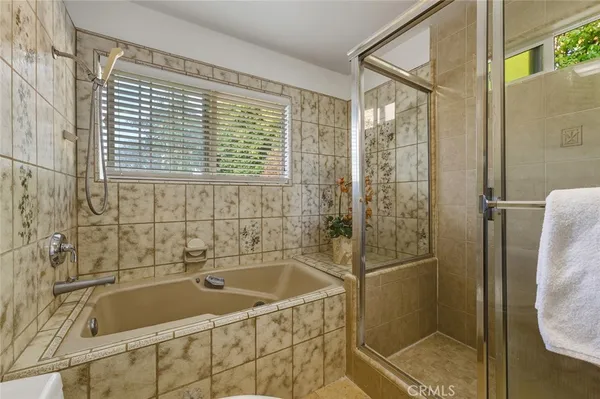 a bathroom with a bathtub and shower