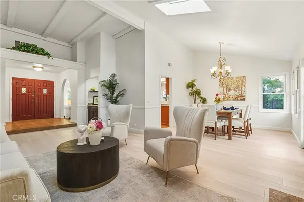 a living room with furniture and a chandelier