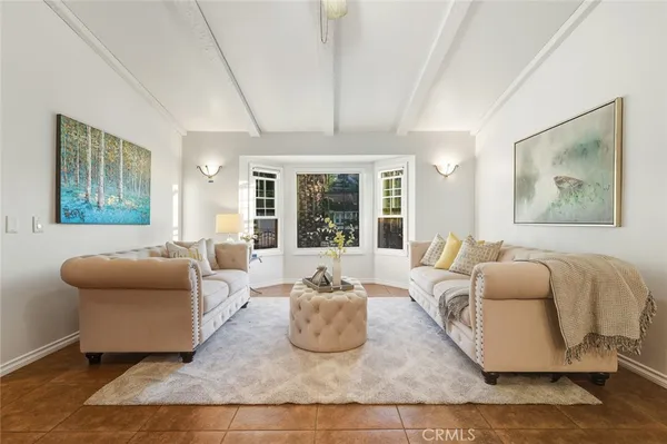 a living room with furniture or chandelier and a wooden floor