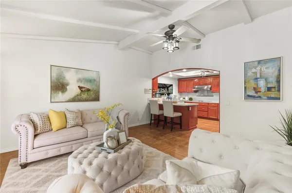 a dining hall with stainless steel appliances granite countertop a sink a stove a dining table and chairs