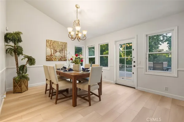 a view of a dining room with furniture and chandelier