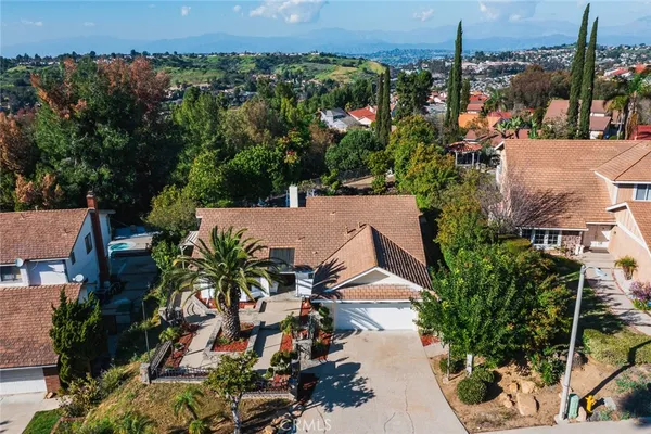 an aerial view of a house with a yard and garden