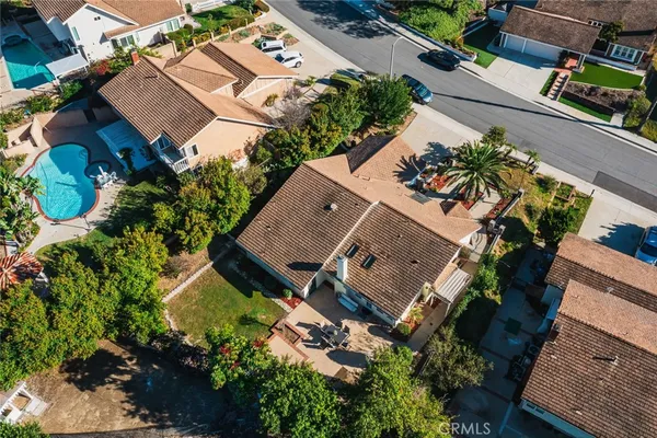 an aerial view of a house with a yard and garden