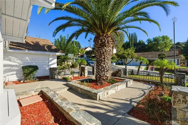 a view of a backyard with swimming pool and furniture