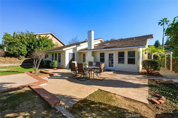 a view of a house with backyard sitting area and porch