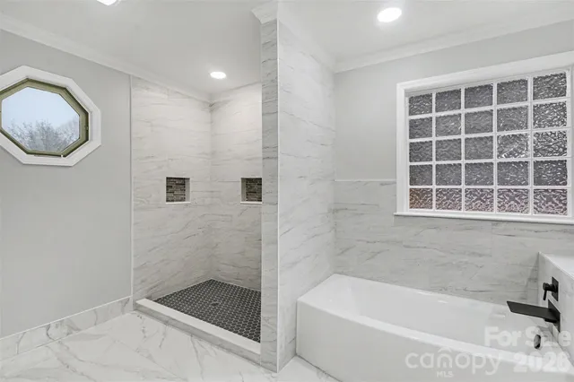 a bathroom with a tub and a shower