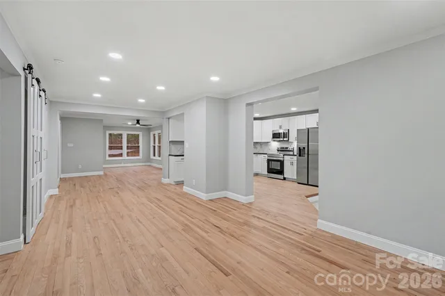 a view of a kitchen with wooden floor and a kitchen