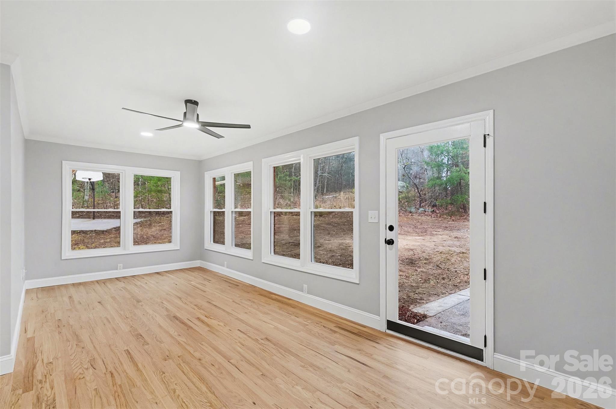 1994 Greenleaf Road Clover, SC 29710 - Photo 7 of 32 a view of an empty room with a window and wooden floor