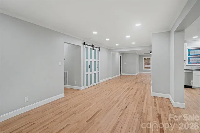 a view of hallway with wooden floor