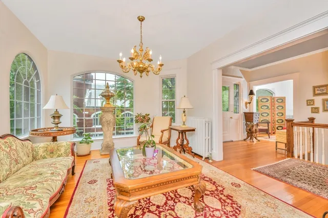 a living room with fireplace furniture and a table