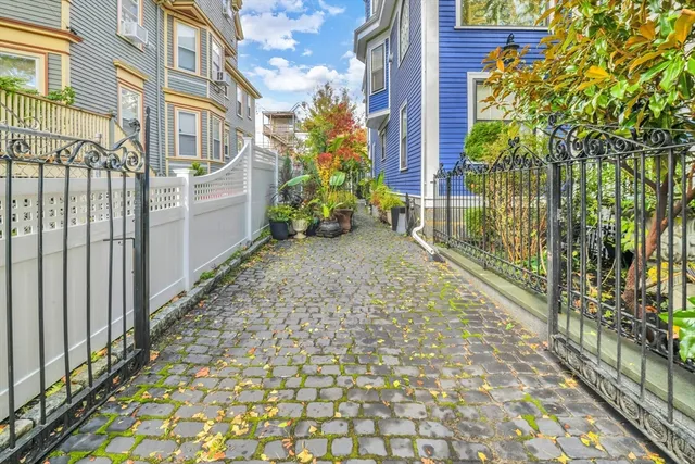 a view of a pathway both side of house