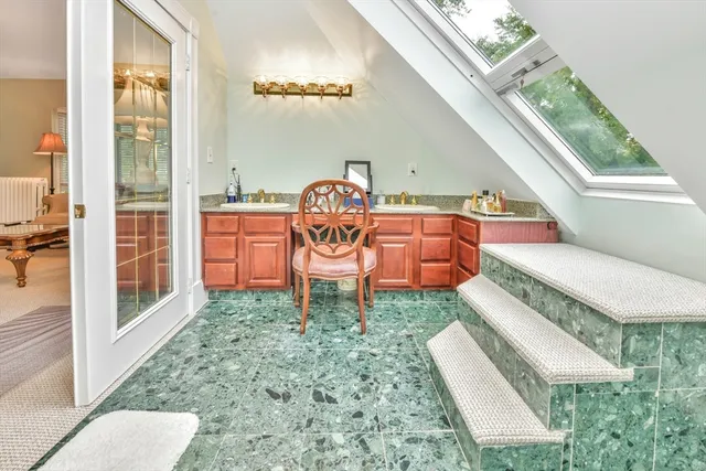 a white bath tub sitting in a bathroom next to a window