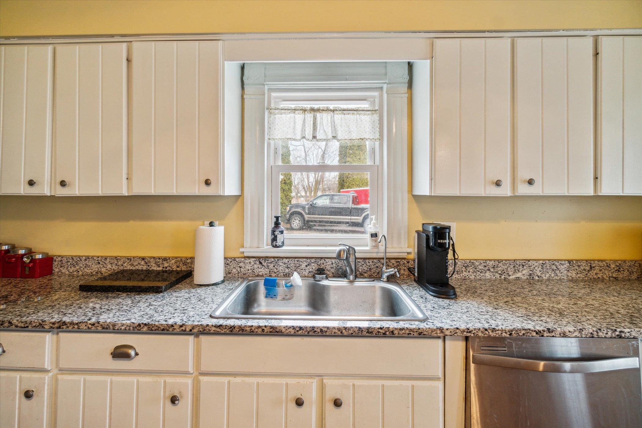 14188 Beloit Road Caledonia, IL 61011 - Photo 19 of 42 a kitchen with granite countertop a sink a stove and cabinets