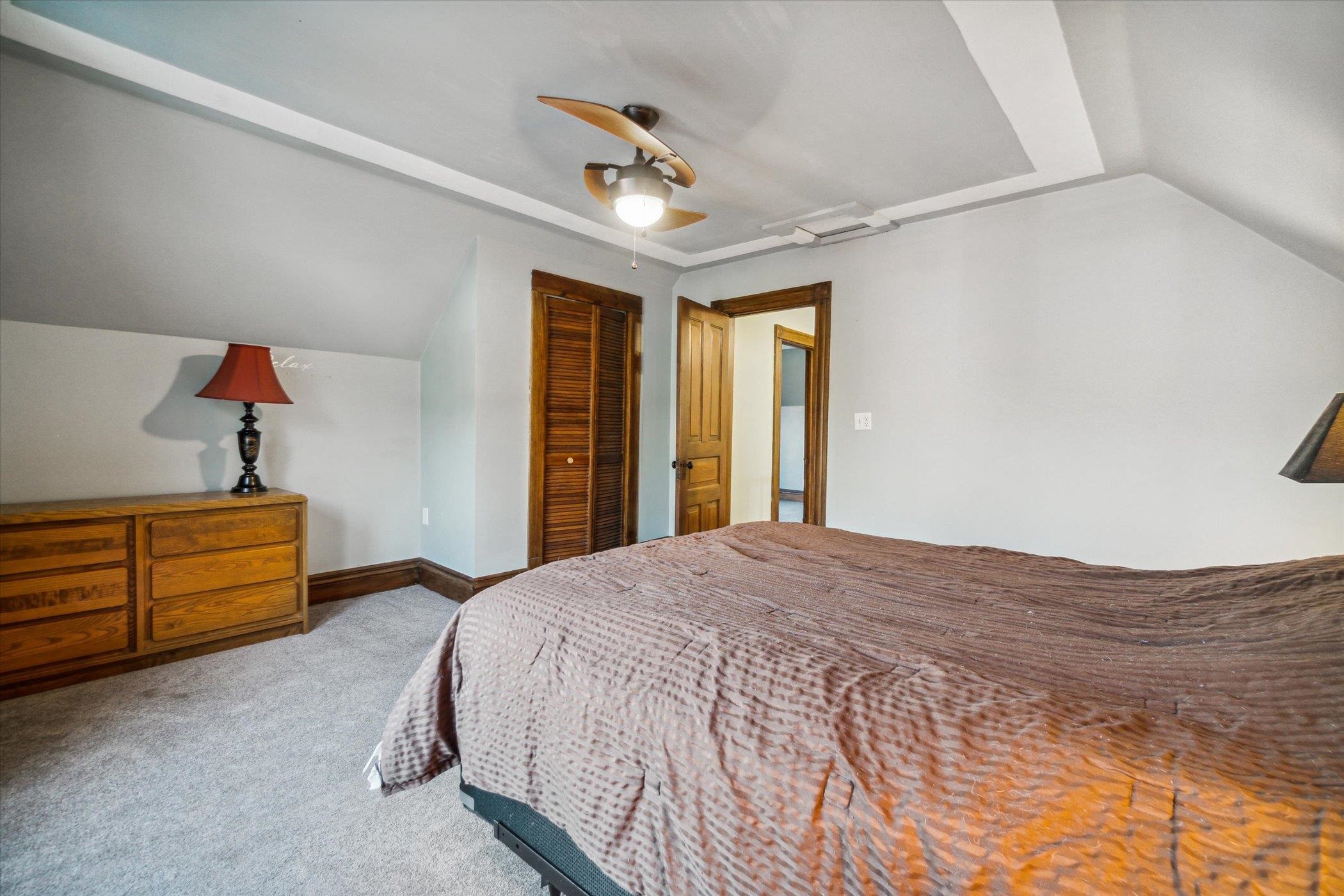 14188 Beloit Road Caledonia, IL 61011 - Photo 22 of 42 a bedroom with a bed and a ceiling fan